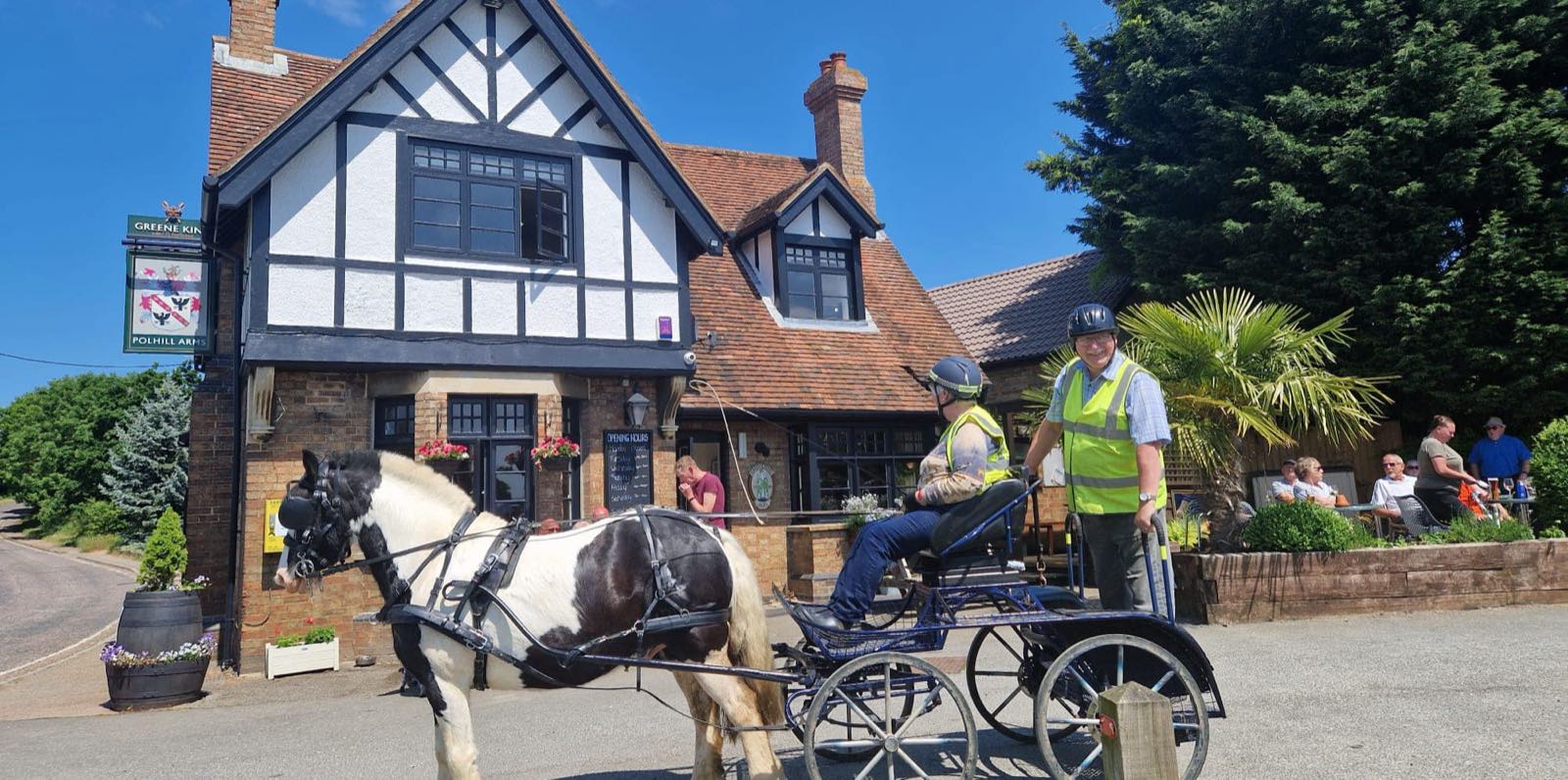 The Polhill Arms, a black-and-white timbered country pub, on a bright summer afternoon